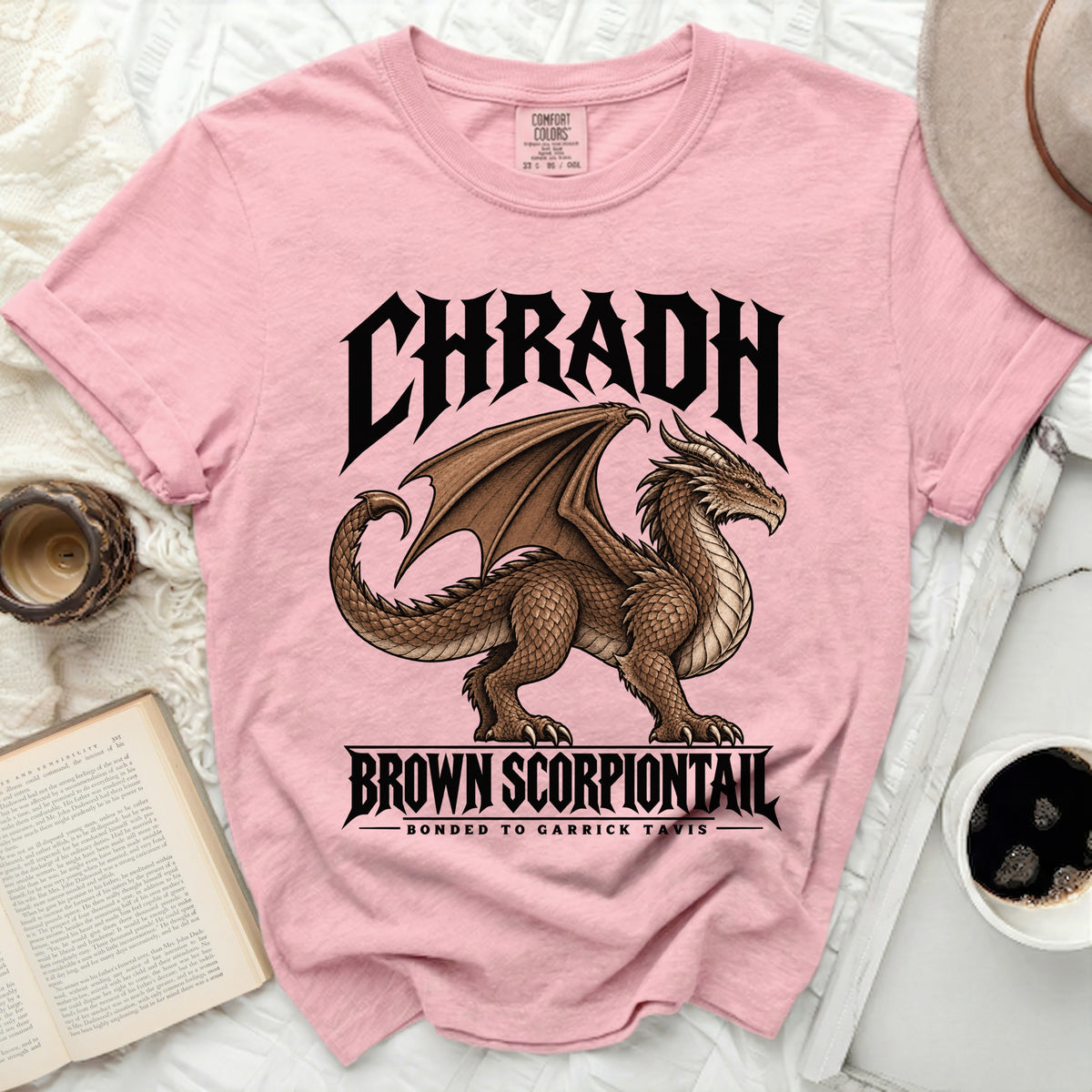 Pink t-shirt with a brown dragon graphic and text "CHRADH BROWN SCORPIONTAIL".