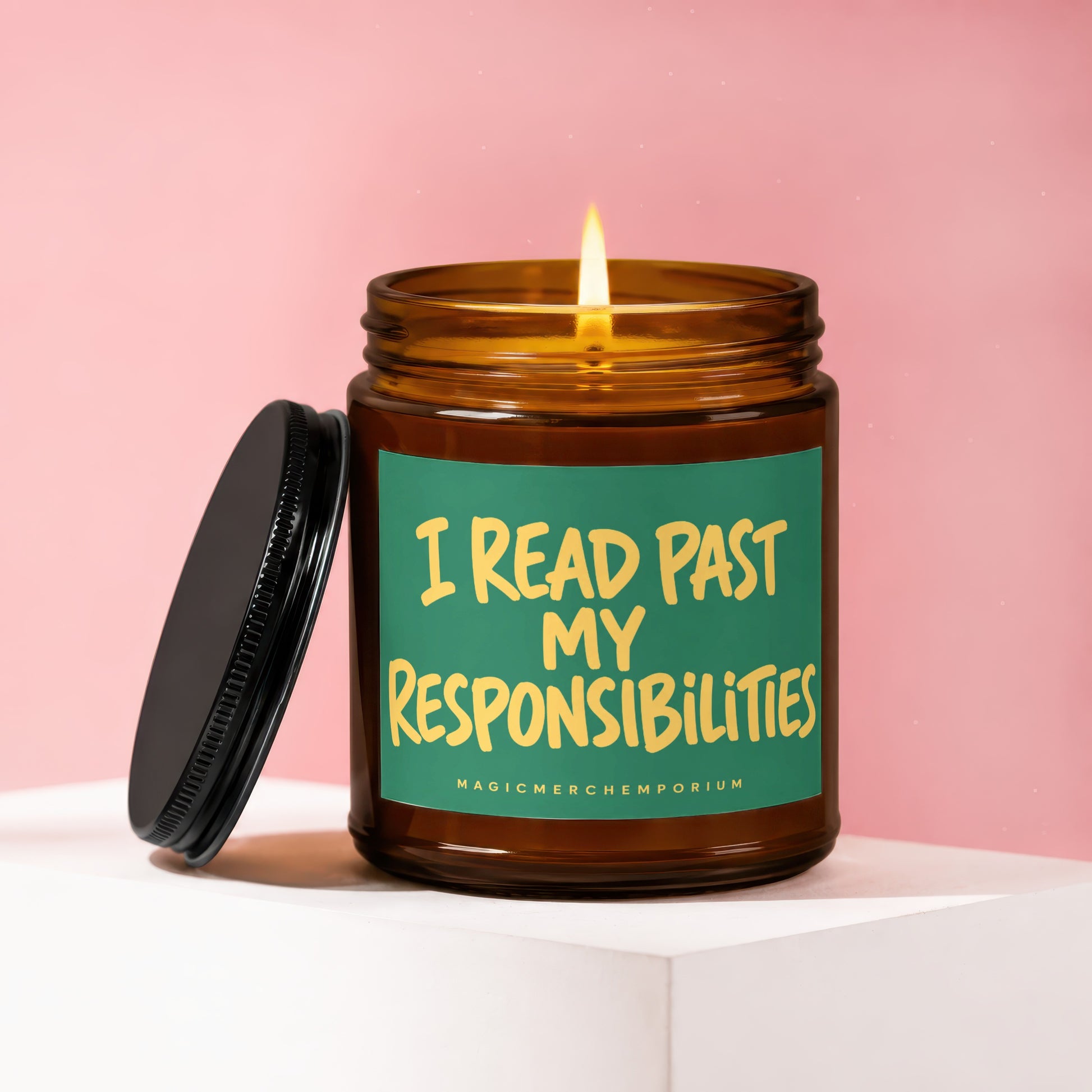 Amber candle with lit wick and green label reading "I READ PAST MY RESPONSIBILITIES".