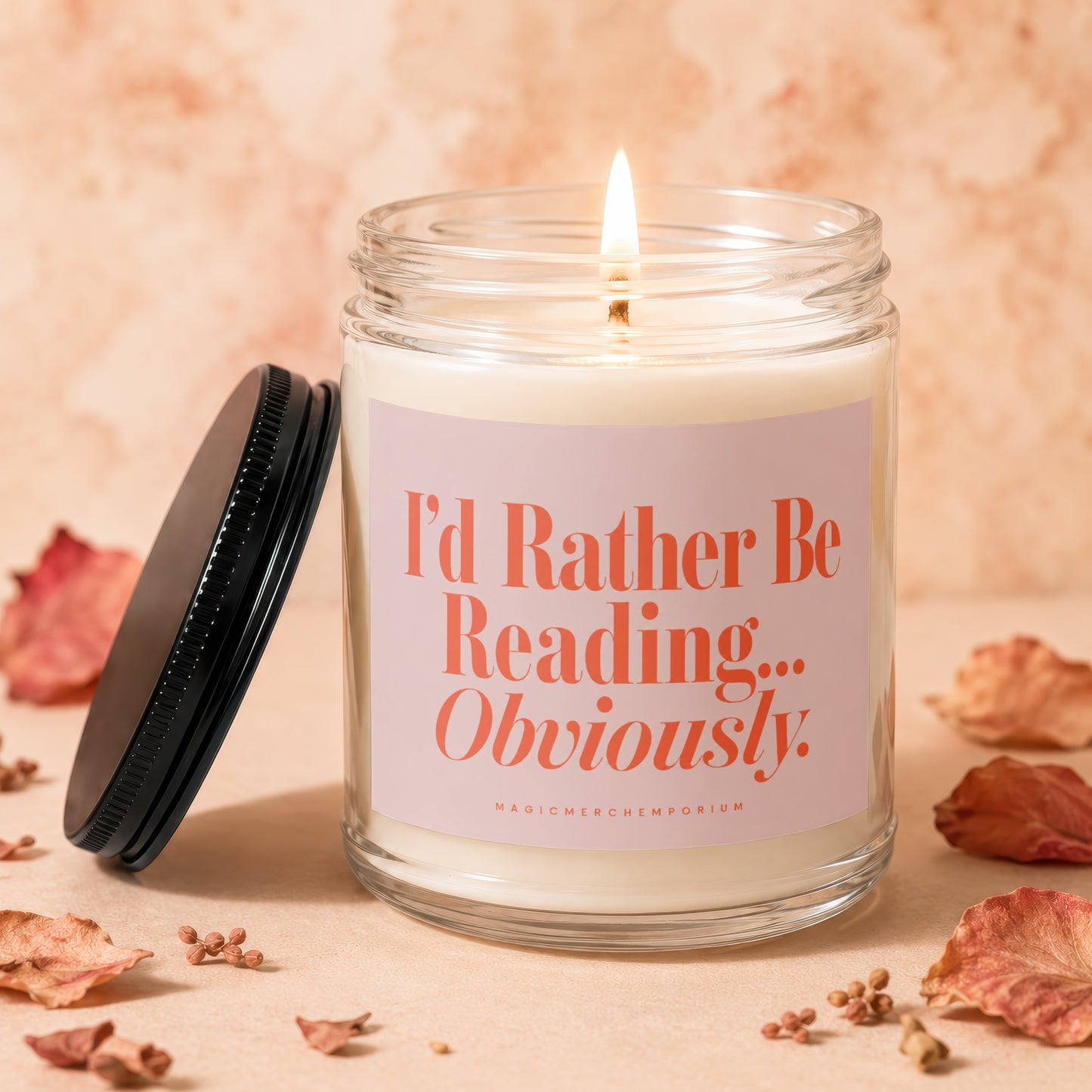 Candle with "I'd Rather Be Reading... Obviously" text on a light pink label.
