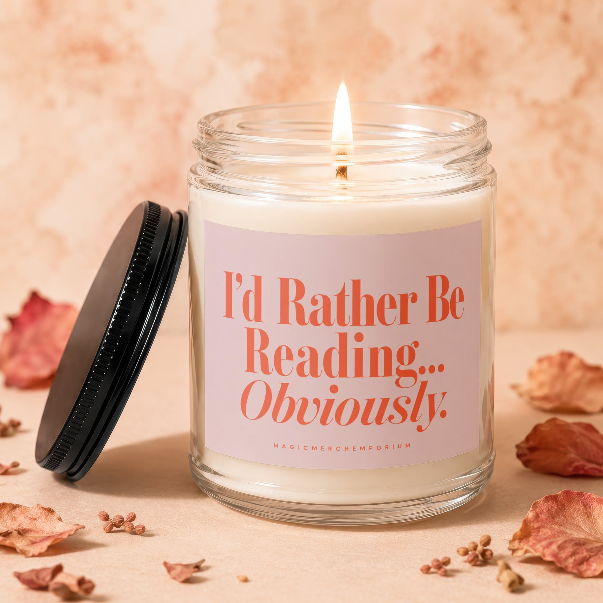 Candle with "I'd Rather Be Reading... Obviously" text on a light pink label.