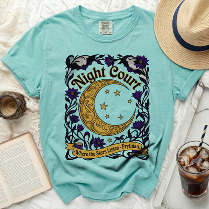 Turquoise t-shirt with "Night Court Where The Stars Listen" crescent moon graphic.