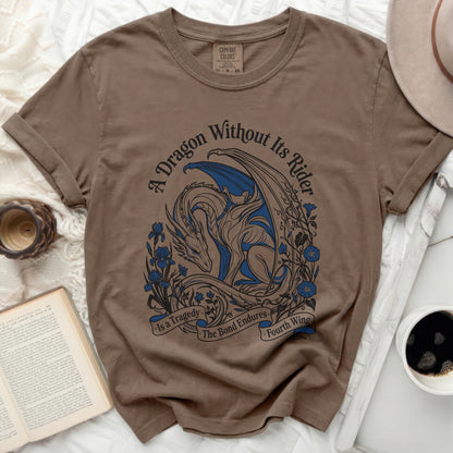 Brown t-shirt with blue dragon and floral design, text reads "A Dragon Without Its Rider is a Tragedy. The Bond Endures. Fourth Wing."