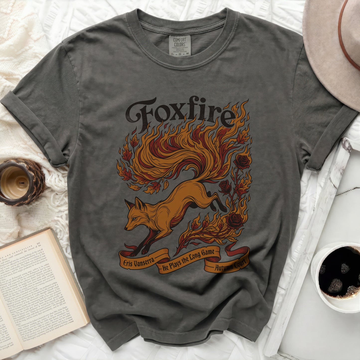 Dark grey Comfort Colors t-shirt with "Foxfire" fox and flame graphic, "Eris Vanserra," and "He Plays the Long Game."