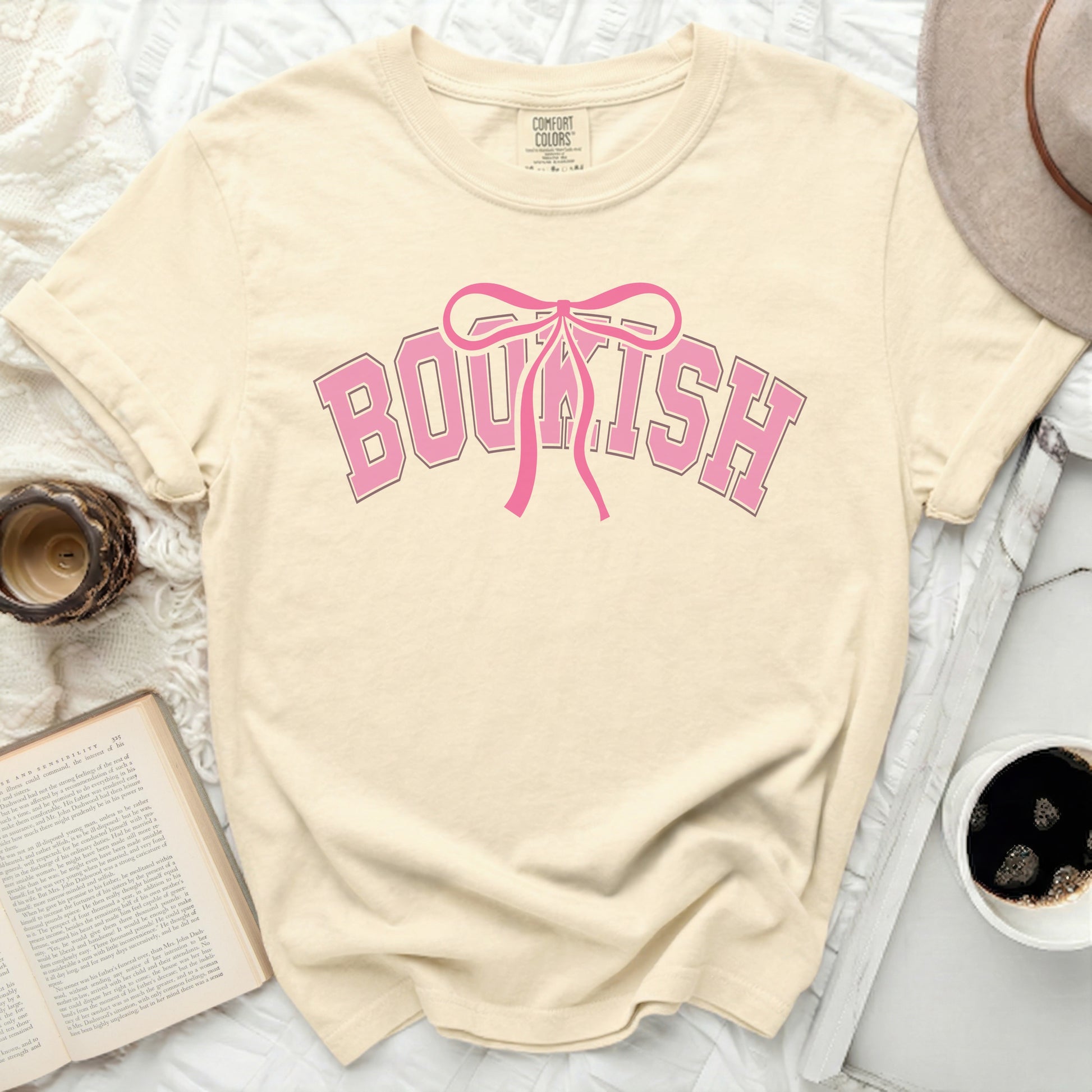 Light cream t-shirt with "BOUKISH" in pink collegiate lettering.