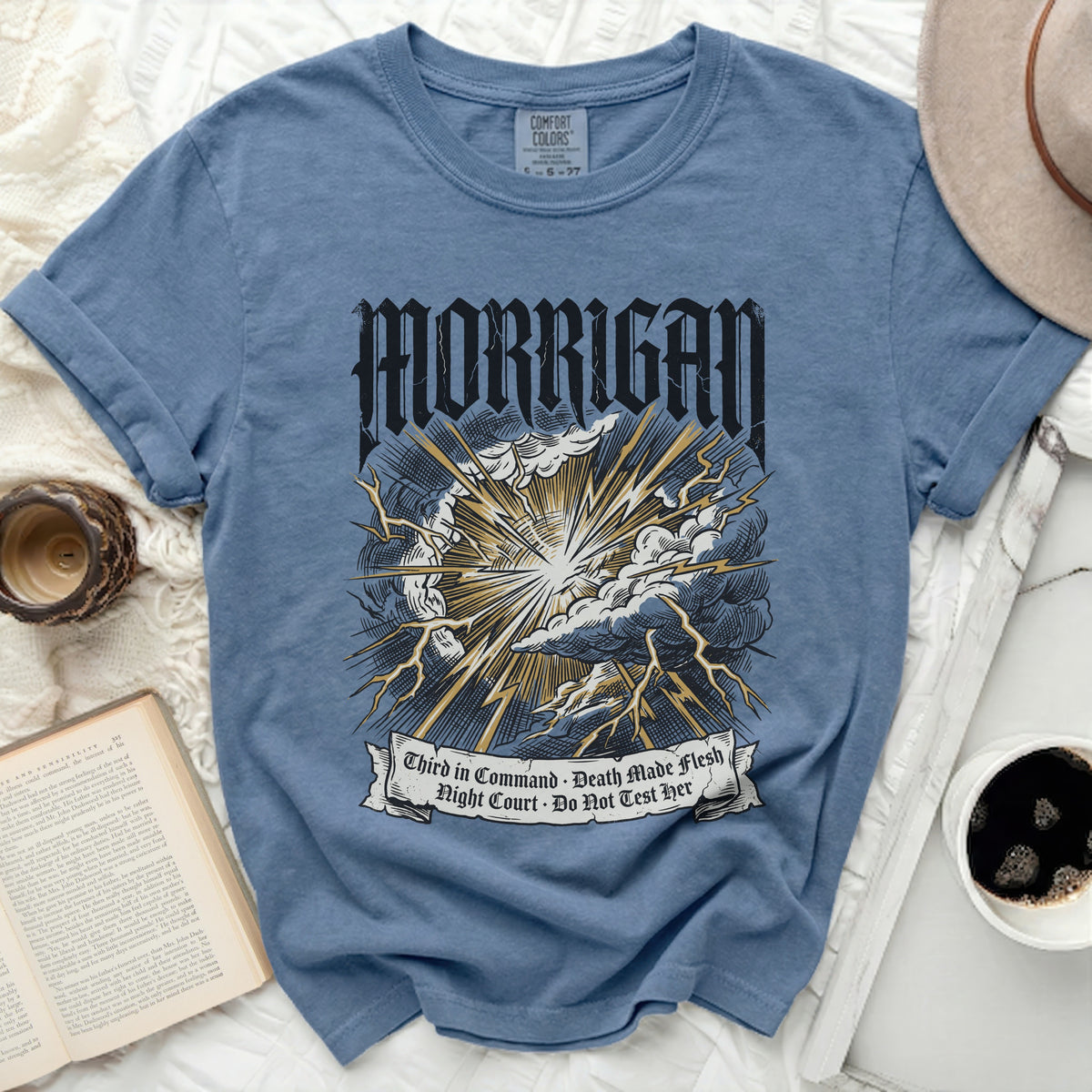Blue t-shirt with "MORRIGAN" and lightning bolt graphic.