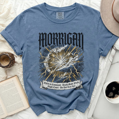 Blue t-shirt with "MORRIGAN" and lightning bolt graphic.