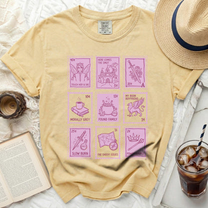 Yellow t-shirt with pink fairytale-themed graphic squares and text.