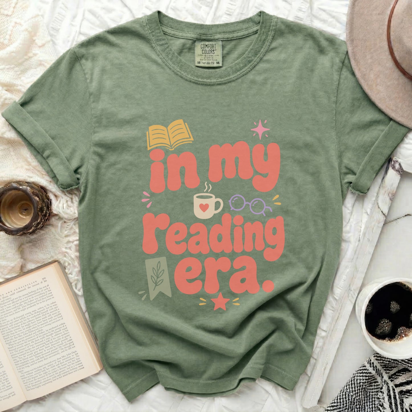 Olive green t-shirt with "in my reading era." text and book graphic.