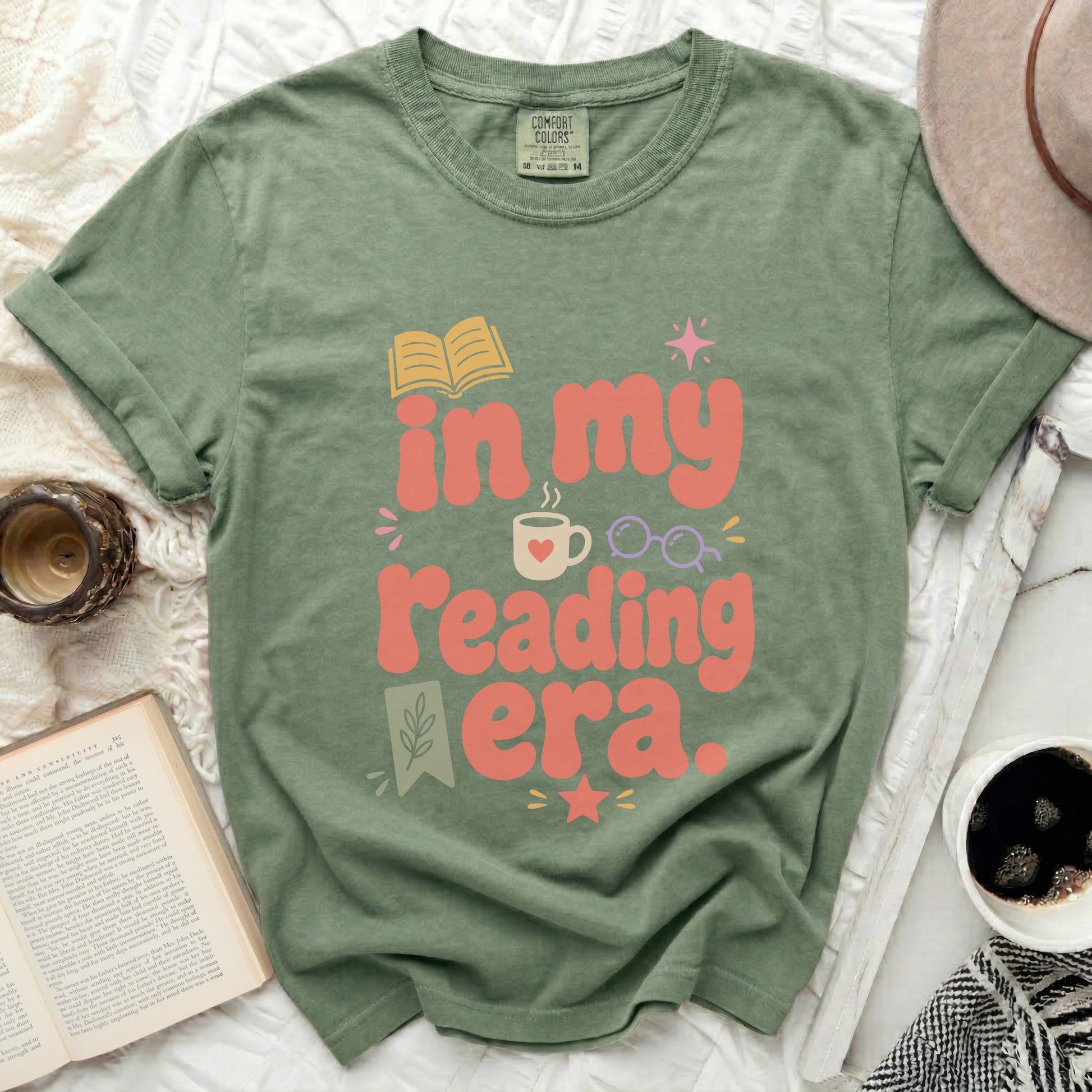 Olive green t-shirt with "in my reading era." text and book graphic.