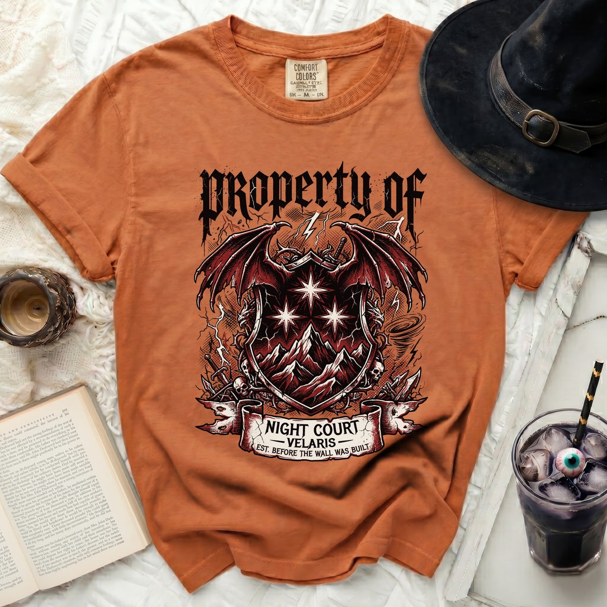 Orange t-shirt with "Property of Night Court Velaris" graphic.