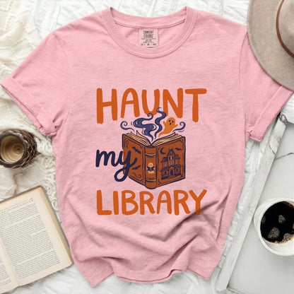Pink comfort colors t-shirt with "Haunt my Library" Halloween graphic.