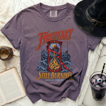 Purple t-shirt with "Fireheart Still Burning Queen of Terrasen" graphic.