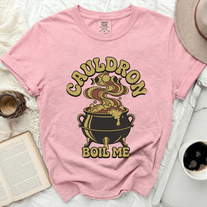 Pink t-shirt with a graphic of a cauldron and the text "CAULDRON BOIL ME".