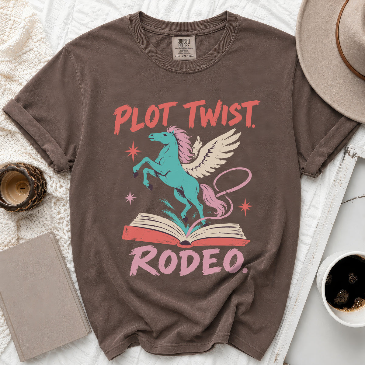 Brown t-shirt with "PLOT TWIST" and "RODEO" text and winged horse graphic.