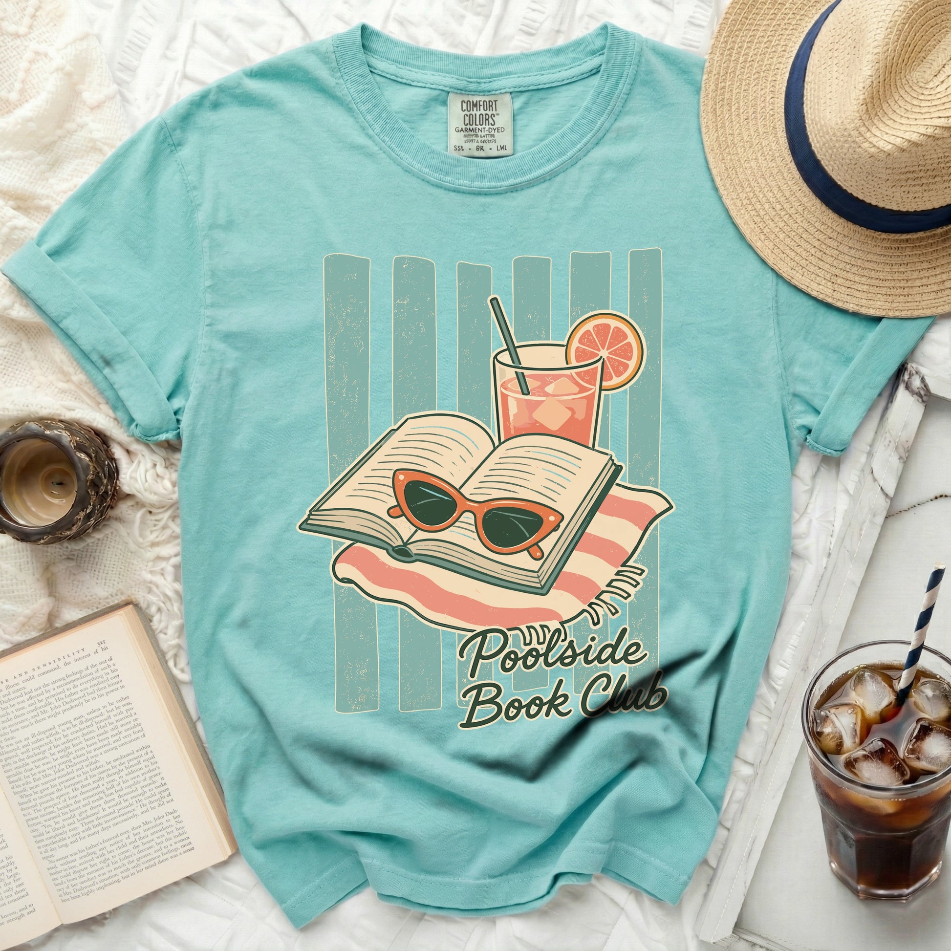 T-shirt with open book, sunglasses, and drink design.