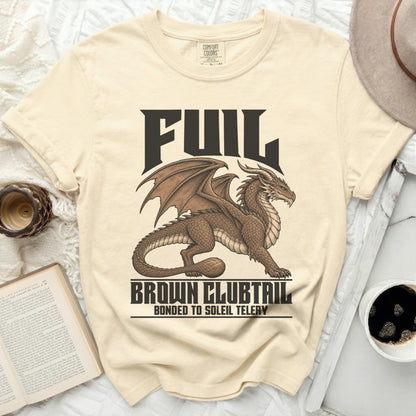 Light yellow t-shirt with a brown dragon graphic and "FUIL BROWN CLUBTAIL BONDED TO SOLEIL TELERY" text.