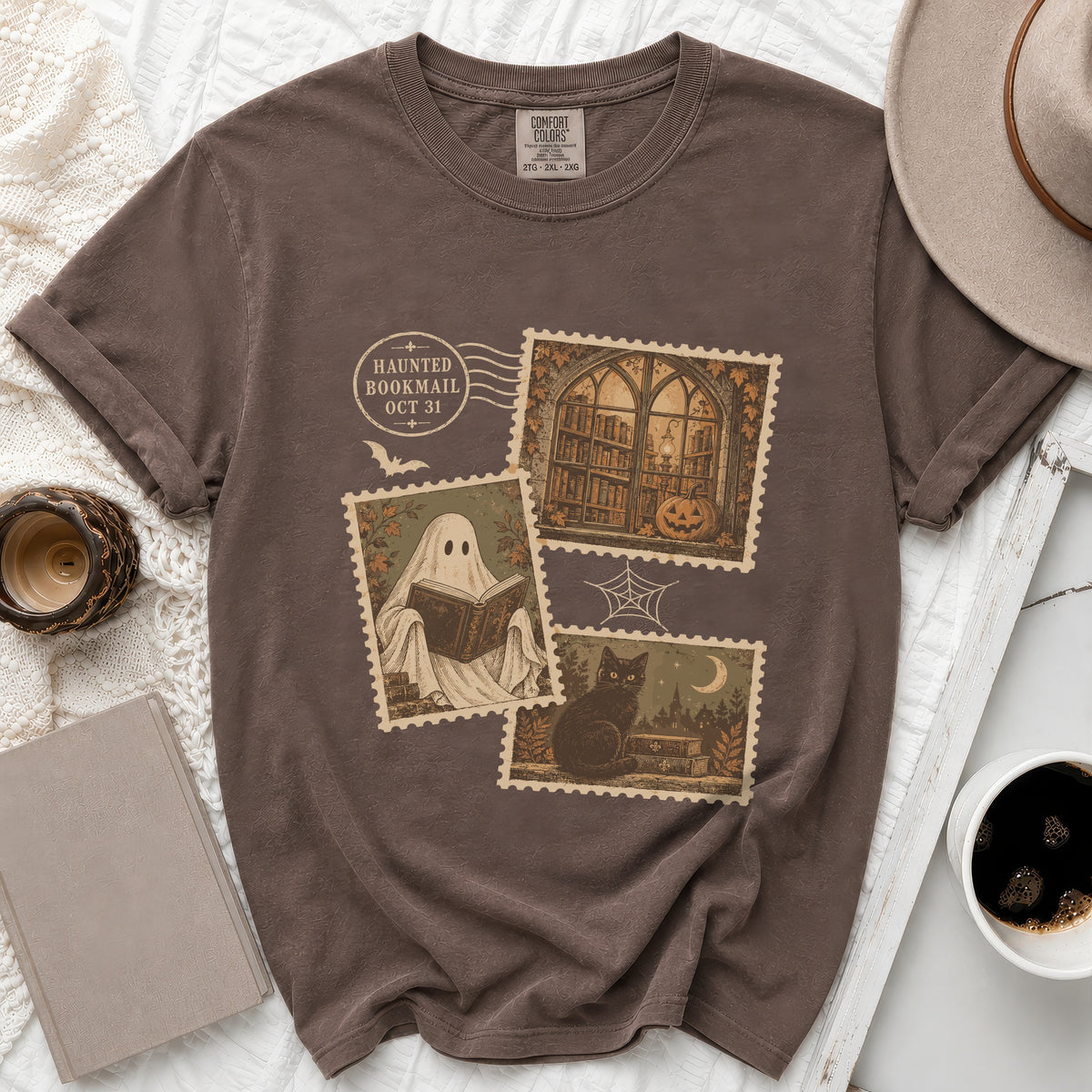Brown t-shirt with "Haunted Bookmail Oct 31" stamp graphic featuring ghost, library, and cat.