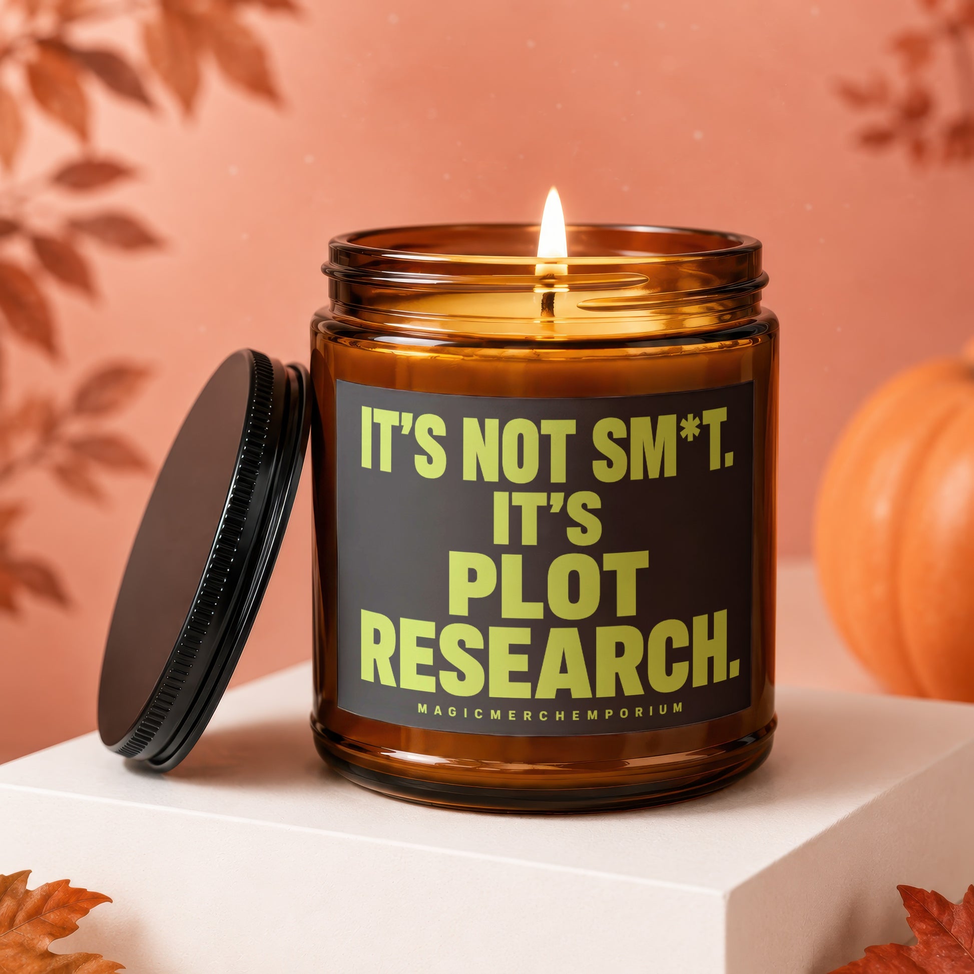 Amber candle with "It's Not Sm*t. It's Plot Research." text and "MagicMerchEmporium".