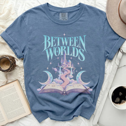Blue t-shirt with "BETWEEN WORLDS" text and a fantasy castle illustration.