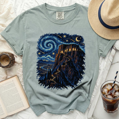 T-shirt with starry night castle design and a book.