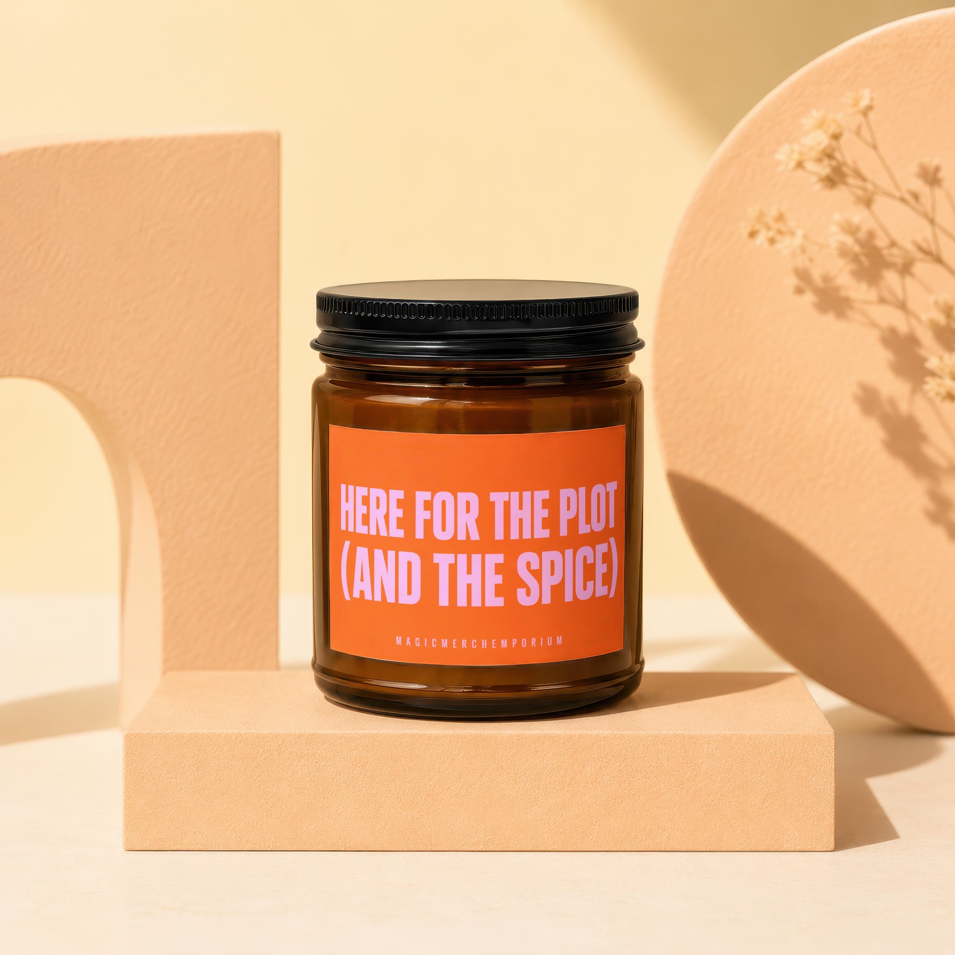 Amber glass candle with label that reads "HERE FOR THE PLOT (AND THE SPICE)".