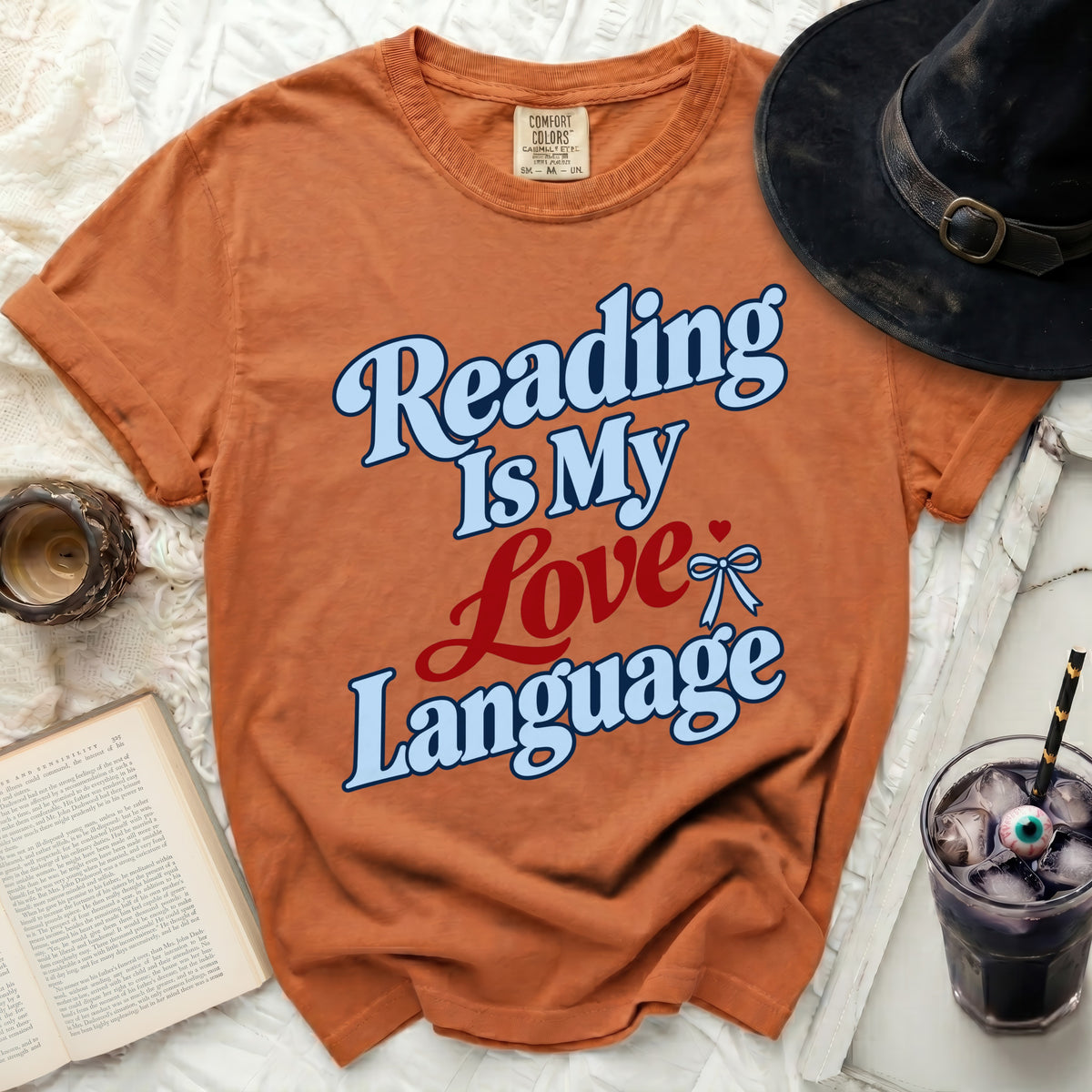 Orange t-shirt with "Reading Is My Love Language" text in blue and red.