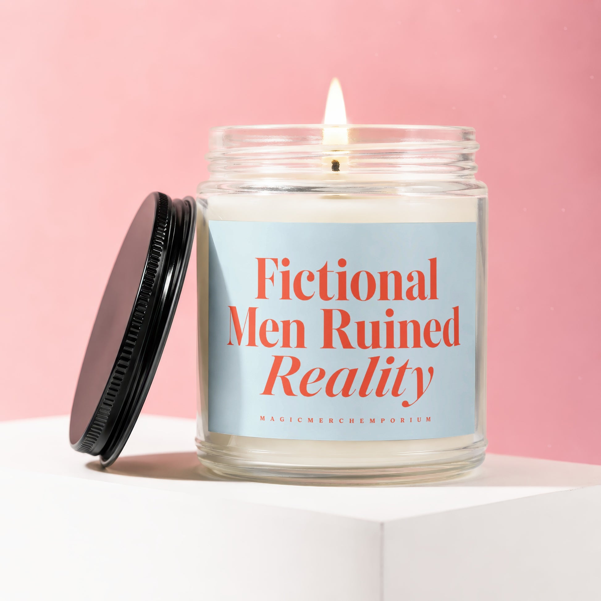 Jar candle with lit flame, reading "Fictional Men Ruined Reality".