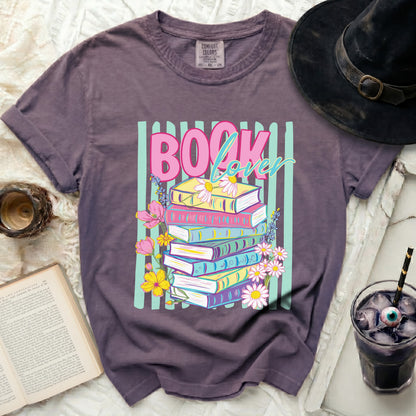 Purple t-shirt with "Book Lover" text and stacked books graphic.