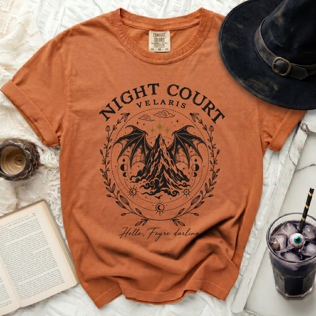 Rust-colored crewneck t-shirt featuring a black graphic of Night Court Velaris with wings and mountains.