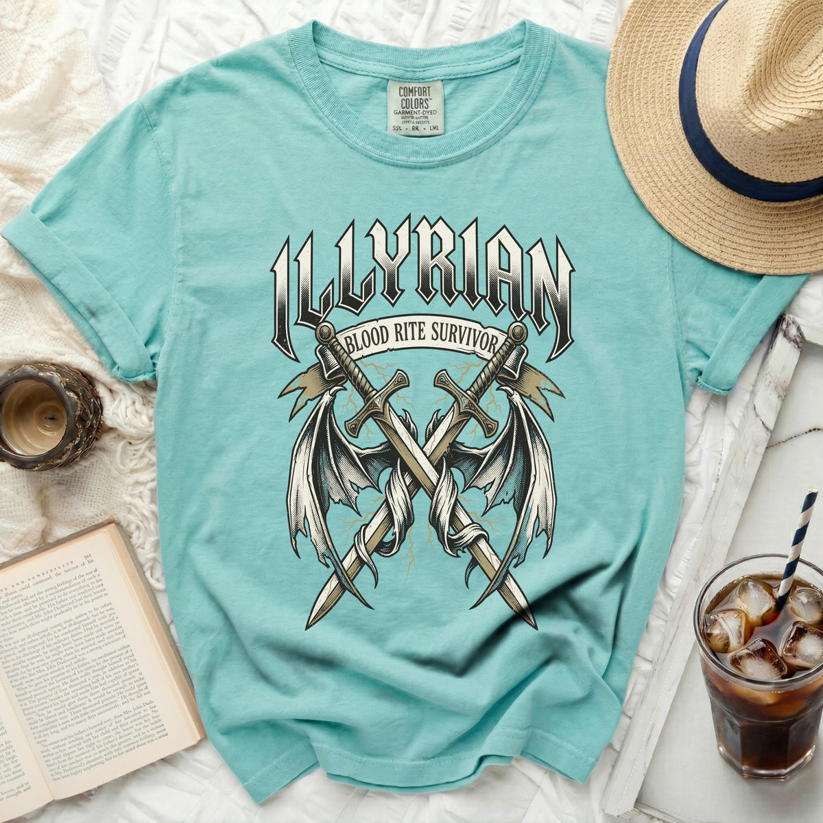 Teal t-shirt with "Illyrian Blood Rite Survivor" and crossed swords graphic.