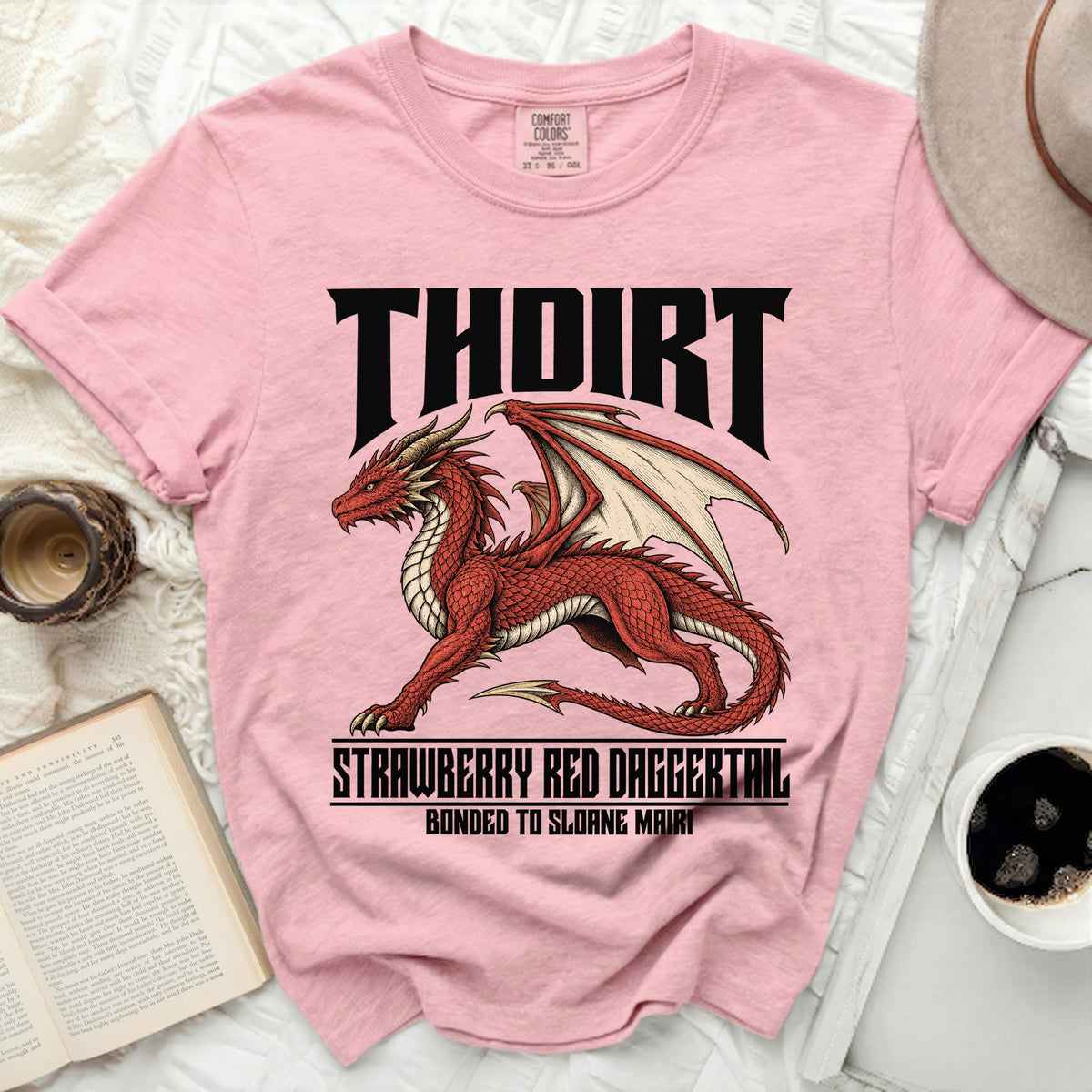 Pink t-shirt with a red dragon graphic and text "THOIRT STRAWBERRY RED DAGGERTAIL BONDED TO SLOANE MAIRI".