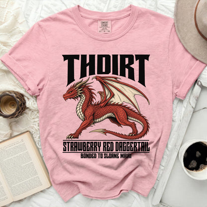 Pink t-shirt with a red dragon graphic and text "THOIRT STRAWBERRY RED DAGGERTAIL BONDED TO SLOANE MAIRI".