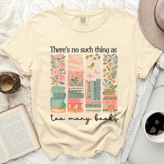 T-shirt with stack of books and floral designs, reads "There's no such thing as too many books."