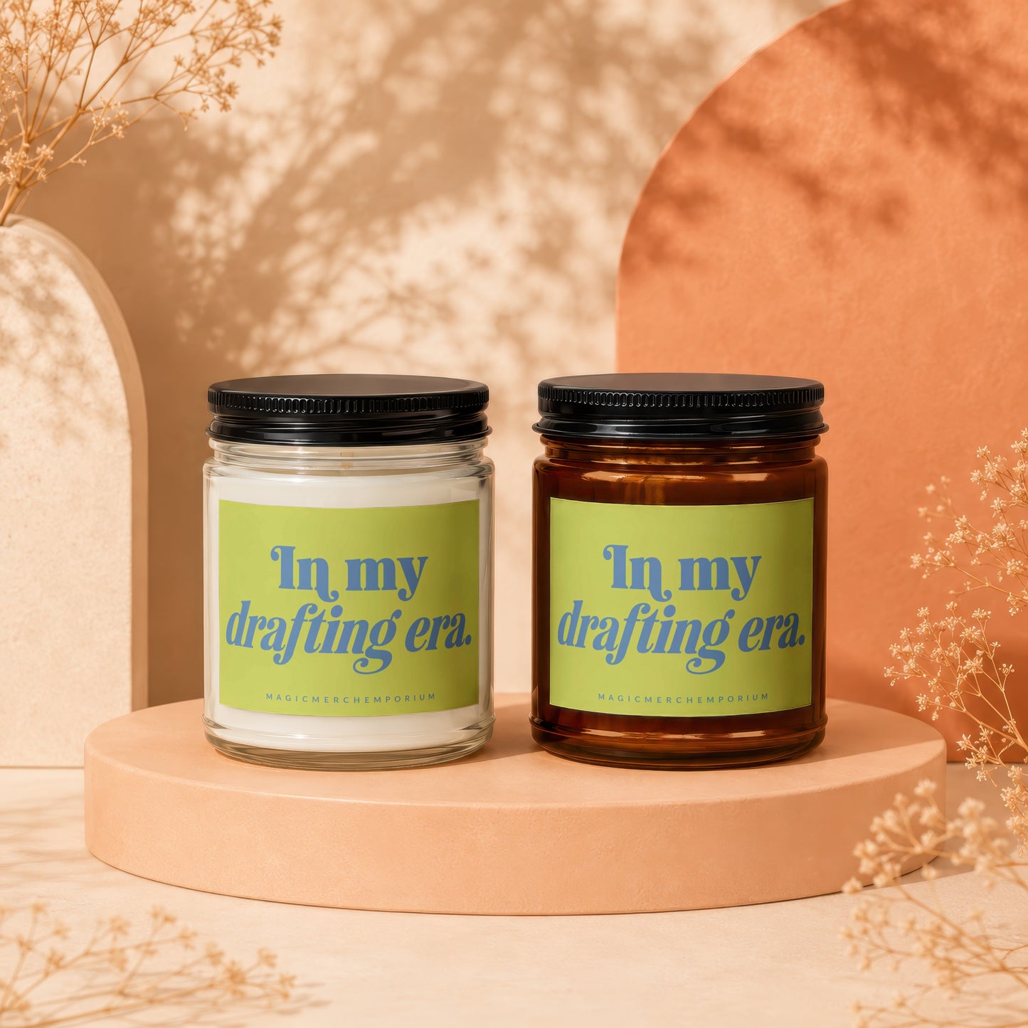 Two candles with green labels reading "In my drafting era."