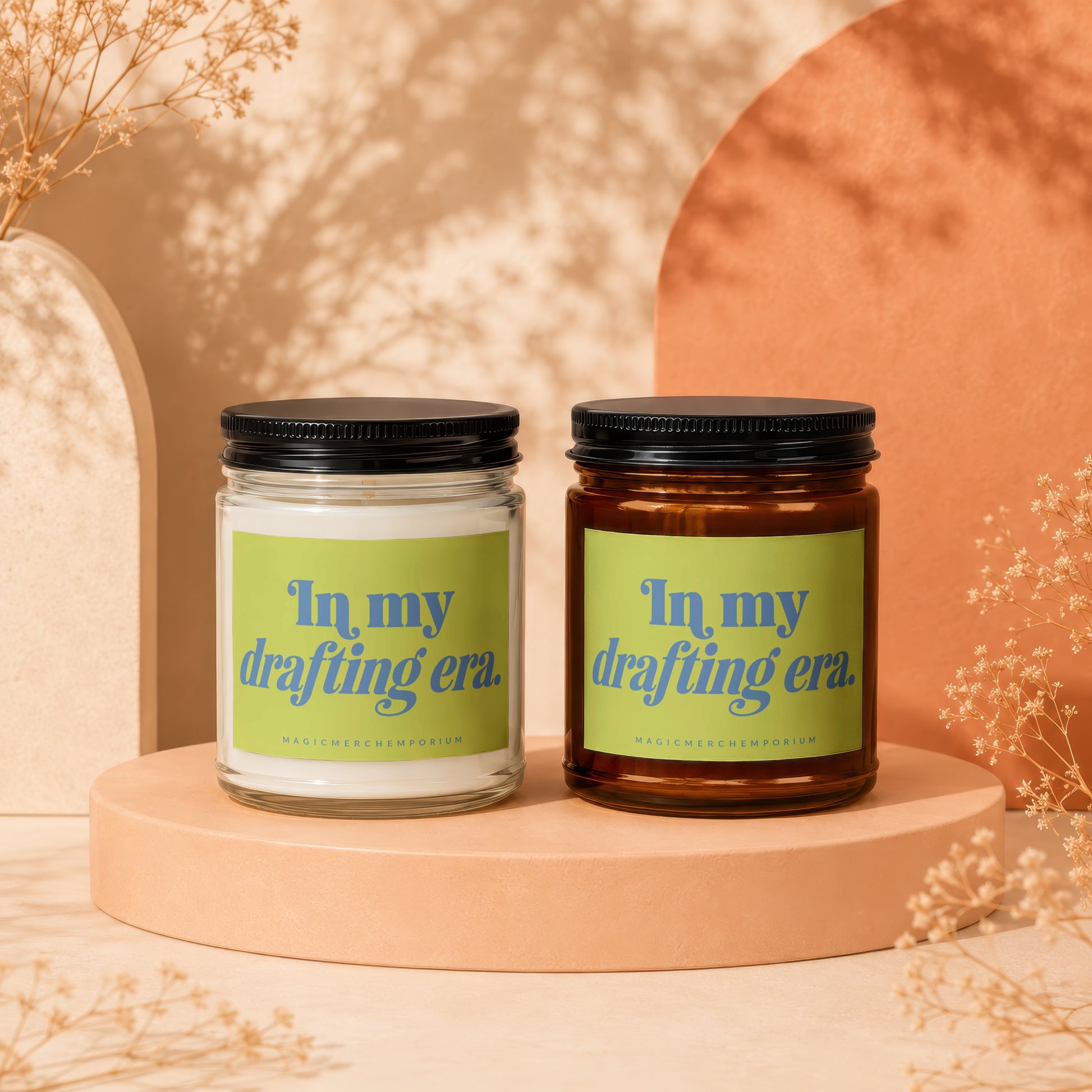 Two candles with green labels reading "In my drafting era."