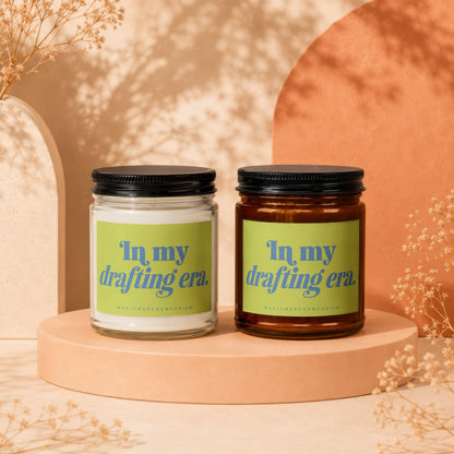Two candles with green labels reading "In my drafting era."