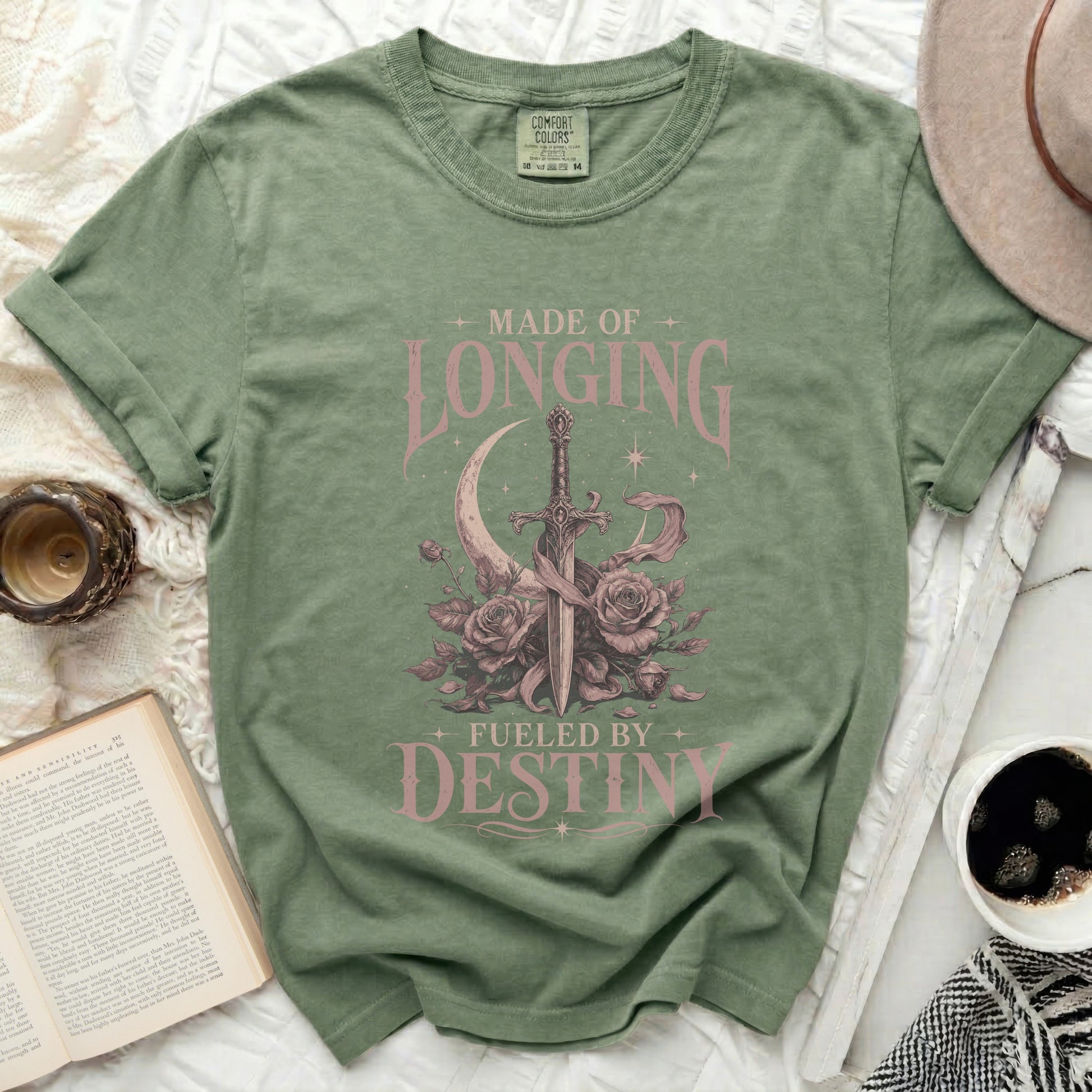 Green t-shirt with "Made of Longing Fueled by Destiny" graphic.