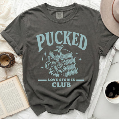 T-shirt with "Pucked Love Stories Club" and ice skates over books.