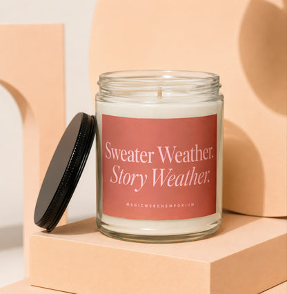 Glass candle with pink label reading "Sweater Weather. Story Weather."
