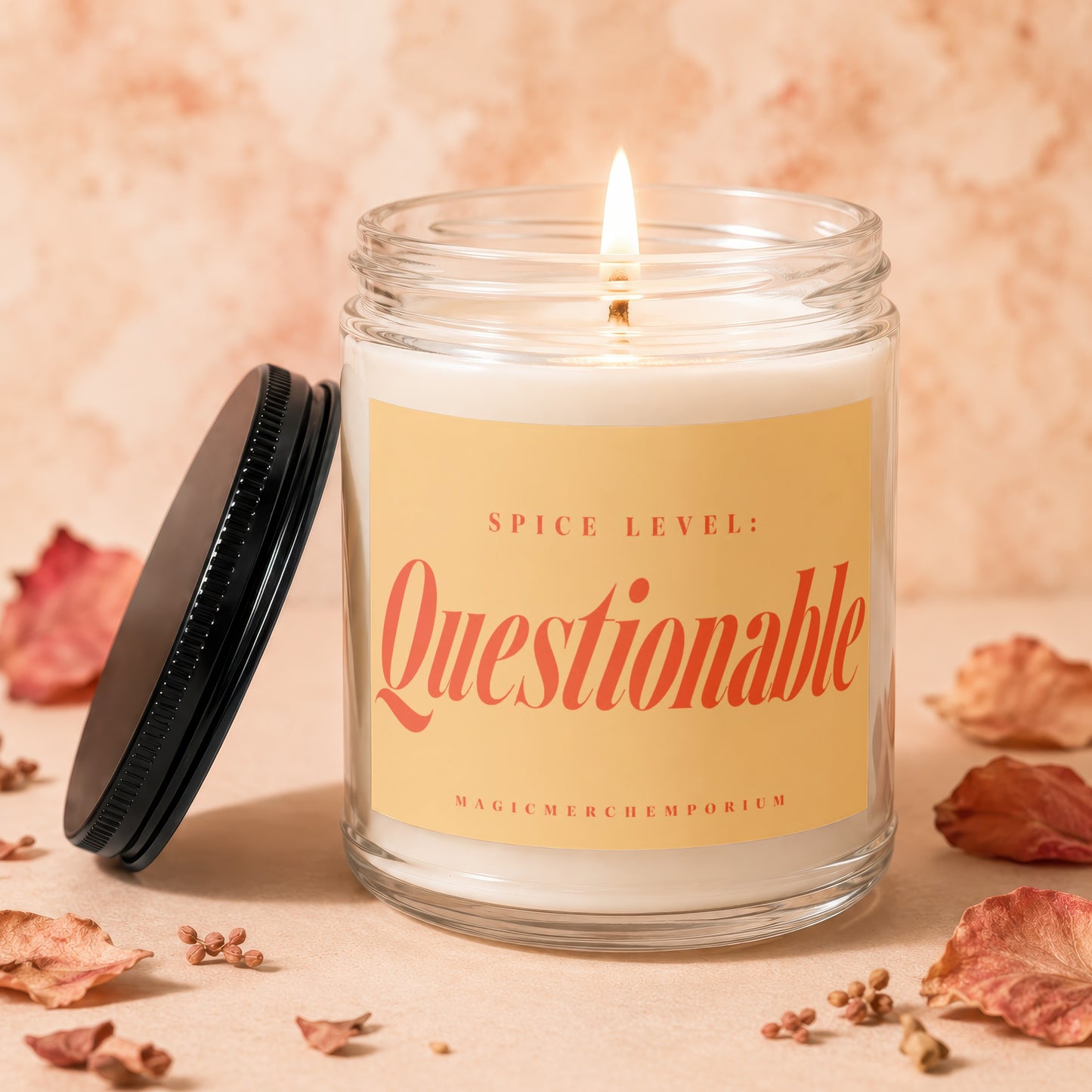 Candle with lit wick and orange label that reads "Spice Level: Questionable".