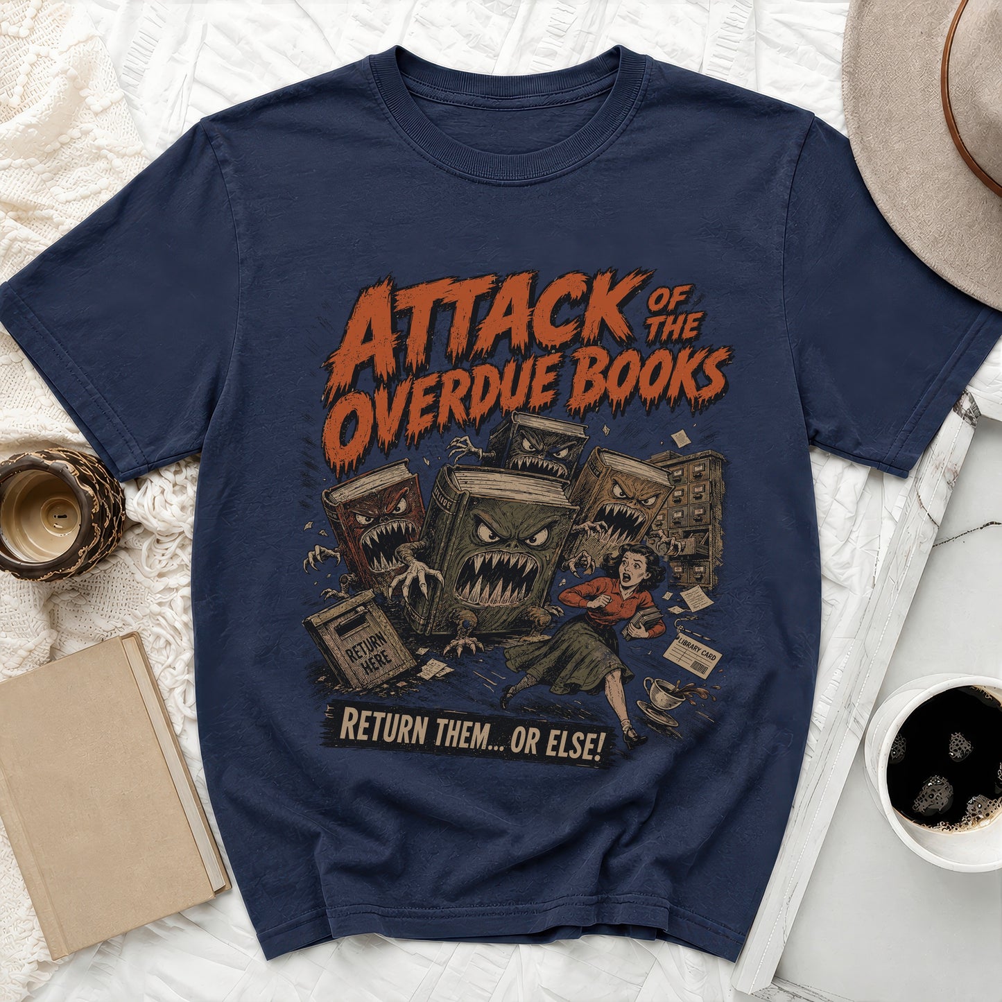 T-shirt graphic: Attack of the Overdue Books with monstrous books chasing a woman.