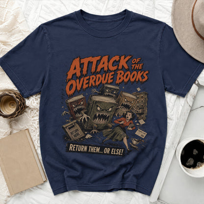 T-shirt graphic: Attack of the Overdue Books with monstrous books chasing a woman.