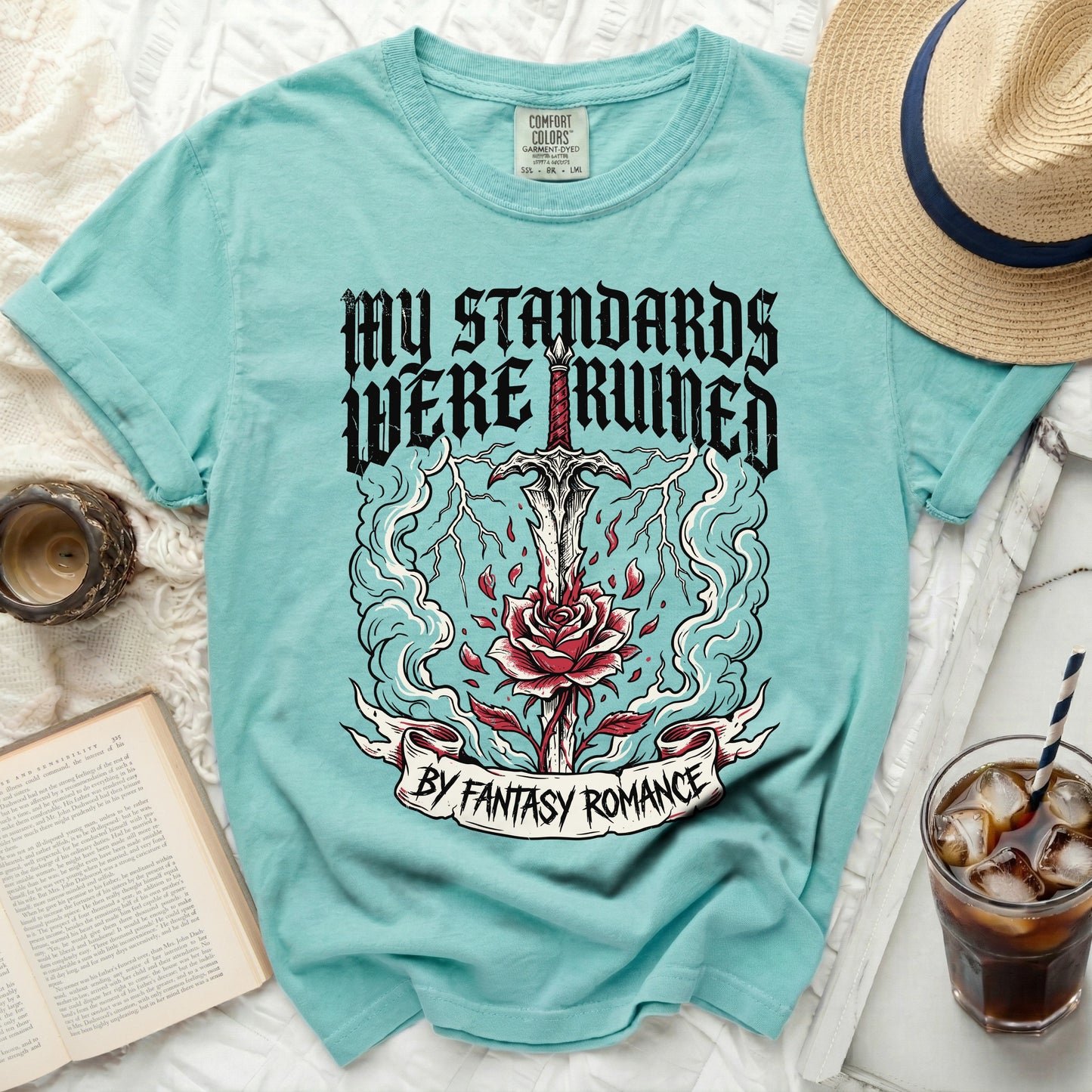 Teal t-shirt with graphic: sword through rose, lightning, and text "MY STANDARDS WERE RUINED BY FANTASY ROMANCE".