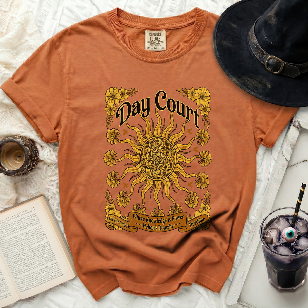 Orange t-shirt with sun, flowers, and text "Day Court".