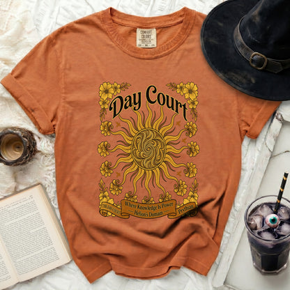Orange t-shirt with sun, flowers, and text "Day Court".