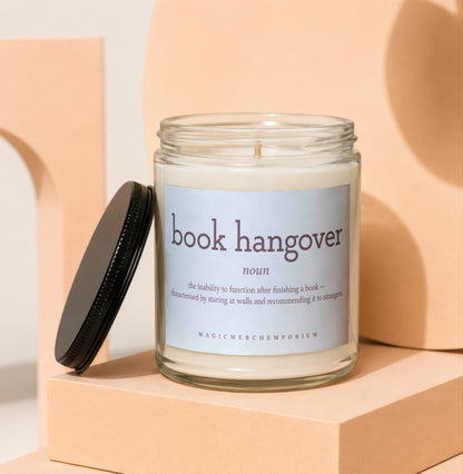 Jar candle with "book hangover" definition and "MAGICMERCHEMPORIUM" logo.