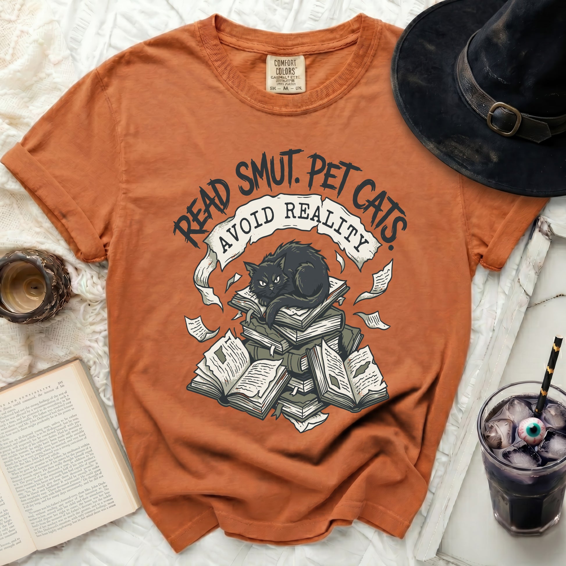 Orange t-shirt with black cat on books graphic and "Read Smut. Pet Cats. Avoid Reality." text.