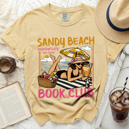 Yellow t-shirt with "Sandy Beach Book Club" graphic of a woman reading.