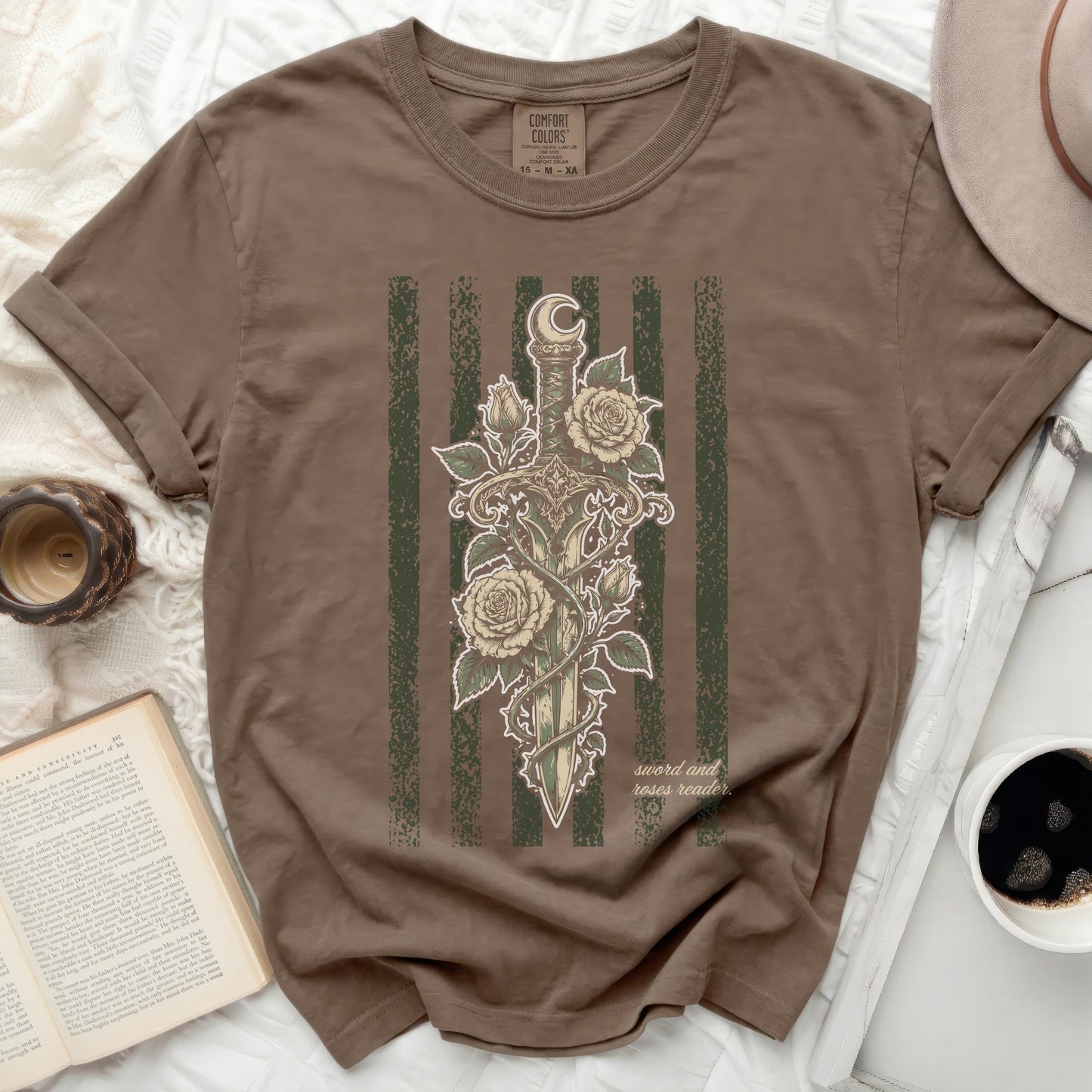 Brown t-shirt with a sword and roses design and "sword and roses reader" text.