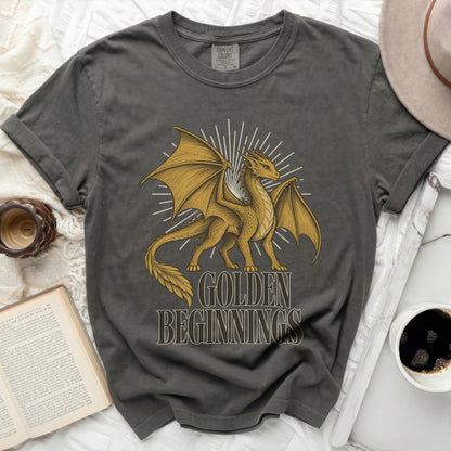 Dark grey t-shirt with a gold dragon graphic and text "GOLDEN BEGINNINGS."